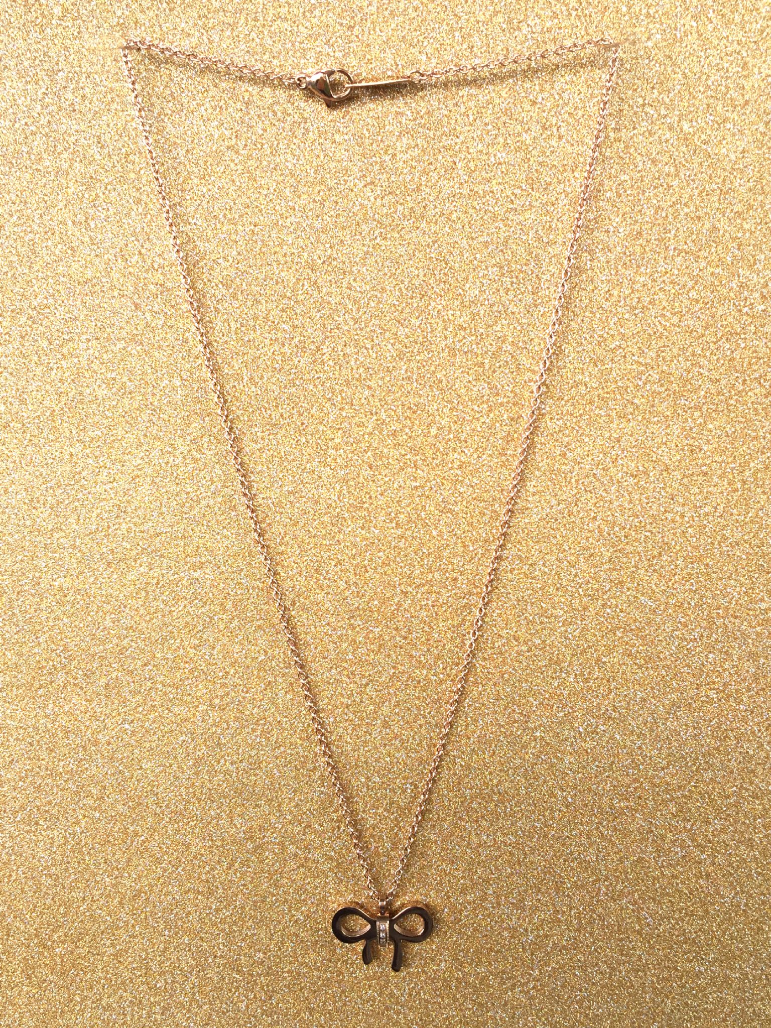 A beautiful butterfly pendant made of mother of pearl and emblazoned with small glittering crystals on a gold metal base. J020010